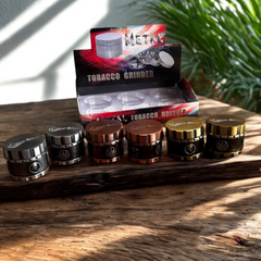 Box of 6 Genie Metal Tobacco Grinders – Magnetic, Skull & Leaf Embossed, Copper Silver Gold