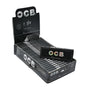 OCB Premium Black Rolling Papers 1¼ – Open display box with 25 neatly arranged packs and one loose pack in front