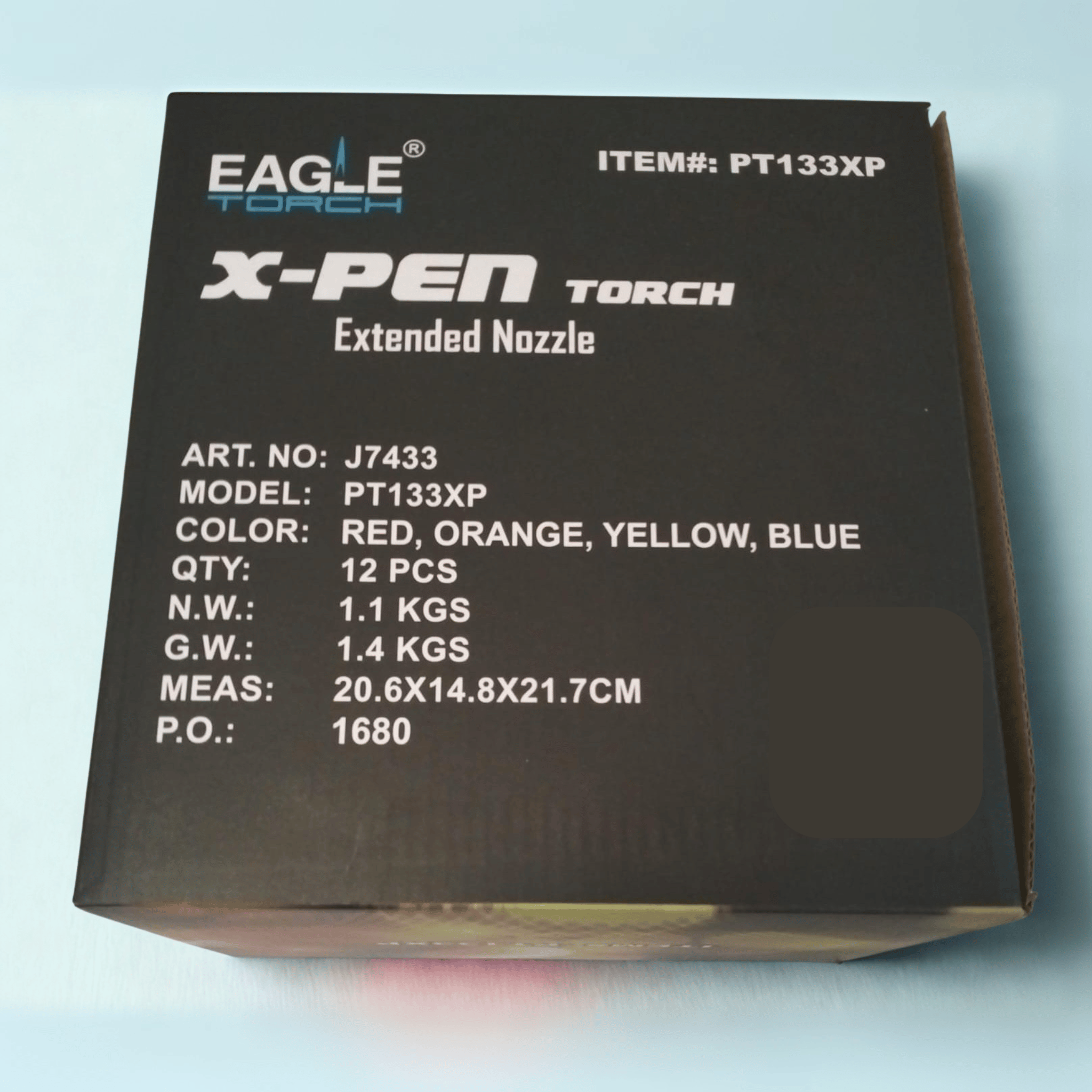 Front of Eagle X-Pen Torch Lighter display box featuring model PT133XP with printed details including Art No, P.O. number, Measurements (MEAS), Color options (Red, Orange, Yellow, Blue), Quantity (QTY), safety information, and brand logo.