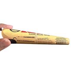 Hand holding a back side of RAW Classic 1¼ Pre-Rolled Cone – Single Pack, 6 Cones in a pack, Water-Based Gumline for Perfect Seal, Clean Taste.