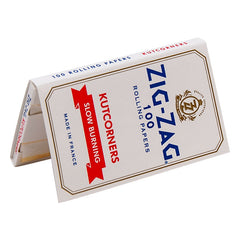 Open Zig-Zag White Kutcorners Rolling Papers single booklet displayed in a triangular shape, showing unrefined, slow-burning papers